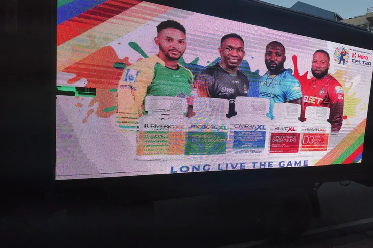 Timesquare truck screen at CPL 2026 showing four cricketers with XL Health products and the line Long Live The Game
